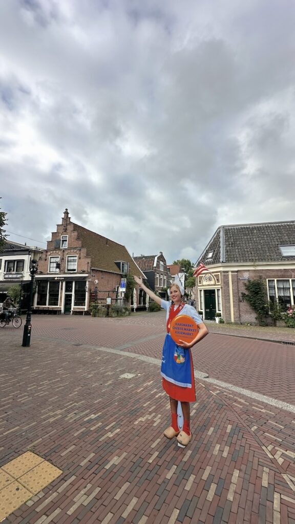 Ein Kaasmeisje weist den Weg zum Kaasmarkt Alkmaar