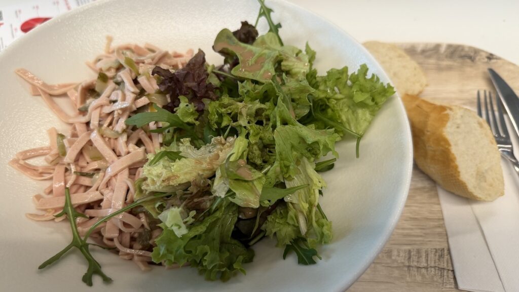 Wurstsalat und etwas grüner Salat vom Salatbüfett